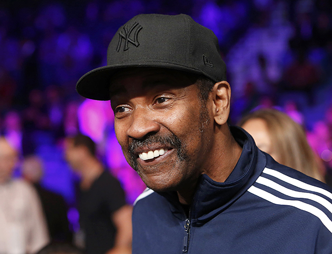 Actor Denzel Washington smiles as he sits ringside while waiting for the welterweight WBO, WBC and WBA (Super) title fight between Manny Pacquiao of the Philippines and Floyd Mayweather, Jr. of the U.S. in Las Vegas, Nevada, May 2, 2015.    REUTERS/Steve Marcus