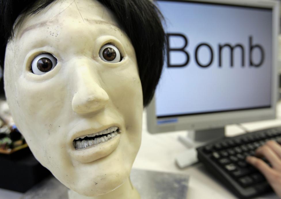 A humanoid robot named Kansei, meaning "sensibility" in Japanese, makes a facial expression depicting "fear", next to the word "Bomb" during a demonstration at a laboratory of Meiji University's Robot and Science Institute in Kawasaki, Japan June 4, 2007. The robot, developed by professor Junichi Takeno and a team of researchers, can make up to 36 kinds of facial expressions after typing a word into its software. The software extracts word associations from a database of 500,000 words and calculates the level, ranging between pleasantness to unpleasantness, which prompts the robot to make facial expressions accordingly. REUTERS/Yuriko Nakao