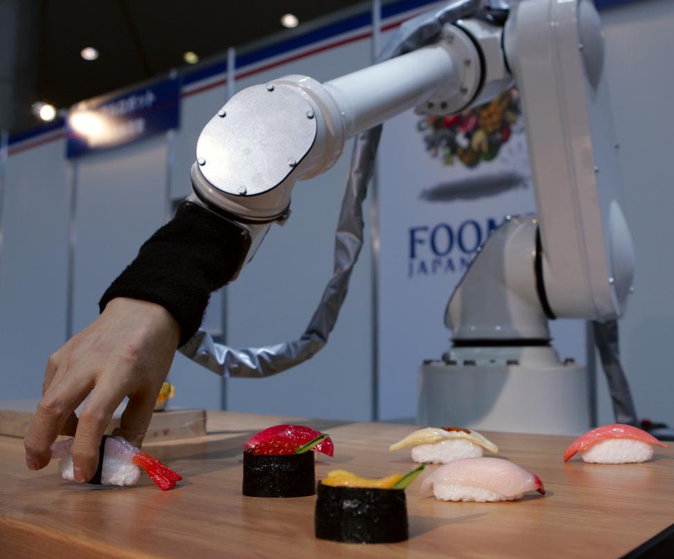 A robot with soft pneumatic fingers handles plastic sushi during a demonstration in Tokyo, Japan June 12, 2009. REUTERS/Michael Caronna