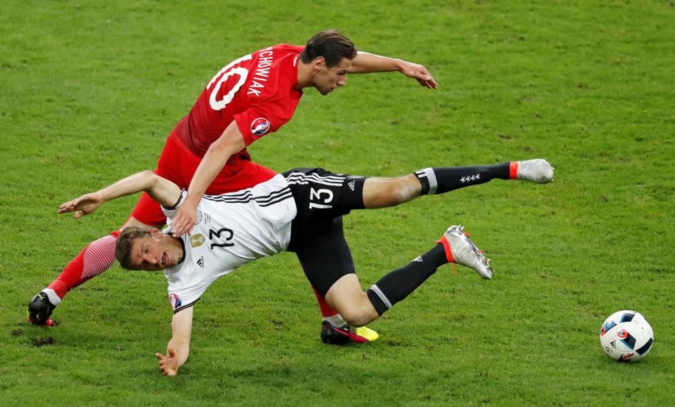 Germany's Thomas Muller in action with Poland's Grzegorz Krychowiak. REUTERS/Charles Platiau Livepic